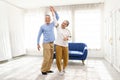 Romantic and cheerful Asian well-being senior couple enjoy dancing and holding hands to music together with smiles and happiness Royalty Free Stock Photo