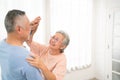 Romantic and cheerful Asian well-being senior couple enjoy dancing and holding hands to music together with smiles and happiness Royalty Free Stock Photo