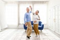 Romantic and cheerful Asian well-being senior couple enjoy dancing and holding hands to music together with smiles and happiness Royalty Free Stock Photo