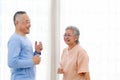 Romantic and cheerful Asian well-being senior couple enjoy dancing and holding hands to music together with smiles and happiness Royalty Free Stock Photo