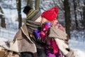 Little girl kissing boy with gift outdoors