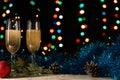 Romantic Christmas and New Year dinner of a couple in love with two glasses of champagne. Blue tinsel and spruce branch with a con Royalty Free Stock Photo