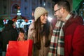 Romantic Christmas shopping. Happy young couple buying gifts for family. Sale and people concept. Royalty Free Stock Photo