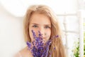 Romantic closeup portrait charming young blonde girl with wildflowers. Little girl with a bouquet of summer flowers. Childhood con Royalty Free Stock Photo