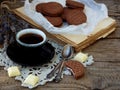 Romantic composition of chocolate cookies with white cream, cup of coffee and bouquet lavender on wooden background. Selective foc Royalty Free Stock Photo
