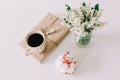 Romantic composition of cupcake, cup of coffee and flowers on white background. Holiday, birthday, Easter, Womens Day concept Royalty Free Stock Photo