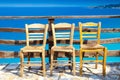 Romantic composition: three chairs and deep blue sea