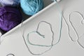 Romantic concept of background from colorful cotton strands designed as a hearts on white table from a yarn balls in box. Royalty Free Stock Photo