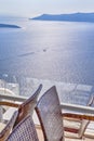 Romantic Concept of Traveling. Open terace View at The Aegean Sea with Line of Boats on Background in Thira City of Santorini