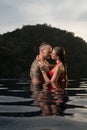 Romantic couple alone in infinity swimming pool