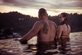 Romantic couple alone in infinity swimming pool