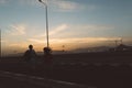 Romantic couple from back running on road on sunset background. Travelling together, being in love, expressing true Royalty Free Stock Photo