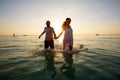 Romantic couple on the beach at colorful sunset on background Royalty Free Stock Photo