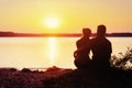 Romantic couple on the beach at colorful sunset background Royalty Free Stock Photo