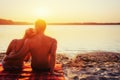 Romantic couple on the beach at colorful sunset background Royalty Free Stock Photo