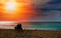 Romantic couple on the beach at colorful sunset on background. Perfect tropical sunset landscape, exotic nature view. Happy Royalty Free Stock Photo