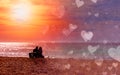 Romantic couple on the beach at colorful sunset on harts background. Perfect tropical sunset landscape, exotic nature view. Happy