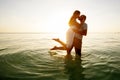 Romantic couple on the beach at sunset on background Royalty Free Stock Photo