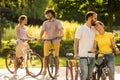 Romantic couple of bicyclists is hugging outdoors.