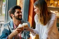 Romantic couple in cafe is drinking coffee and enjoying being together Royalty Free Stock Photo