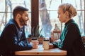 Romantic couple in the cafe is drinking coffee and talking. Royalty Free Stock Photo