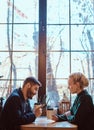 Romantic couple in the cafe is drinking coffee and talking. Royalty Free Stock Photo