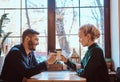 Romantic couple in the cafe is drinking coffee and talking. Royalty Free Stock Photo