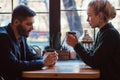 Romantic couple in the cafe is drinking coffee and talking. Royalty Free Stock Photo