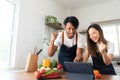 Romantic couple is cooking on kitchen. Handsome man and attractive young woman are having fun together while making Royalty Free Stock Photo