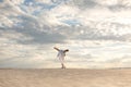 Romantic couple dancing in sand desert. The guy lifts the girl above himself. Sunset sky Royalty Free Stock Photo