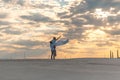 Romantic couple dancing in sand desert. The guy lifts the girl above himself. Sunset sky Royalty Free Stock Photo