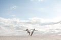 Romantic couple dancing in sand desert. The guy lifts the girl above himself. Sunset sky Royalty Free Stock Photo