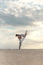 Romantic couple dancing in sand desert. The guy lifts the girl above himself. Sunset sky Royalty Free Stock Photo