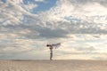 Romantic couple dancing in sand desert. The guy lifts the girl above himself. Sunset sky Royalty Free Stock Photo