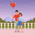 Romantic couple on the date. Man holding balloon in heart shape. Fence, starry sky, mountains and green bushes on Royalty Free Stock Photo