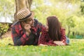 Romantic couple are dating in the park. lovers lying on the lawn looking at each other eyes Royalty Free Stock Photo