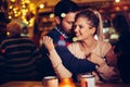 Romantic couple dating in pub at night Royalty Free Stock Photo