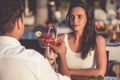 Romantic couple drinking cocktails in restaurant at the beach Royalty Free Stock Photo