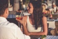 Romantic couple drinking cocktails in restaurant at the beach Royalty Free Stock Photo