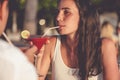 Romantic couple drinking cocktails in restaurant at the beach Royalty Free Stock Photo