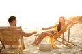 Romantic couple drinking wine on beach at sunset Royalty Free Stock Photo