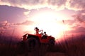 Romantic couple driving an old jeep car in grass field Royalty Free Stock Photo