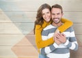 Romantic couple embracing each other against wooden background Royalty Free Stock Photo