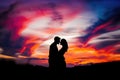 Romantic Couple Embracing In Front Of Vibrant Sunset Sealed With A Kiss