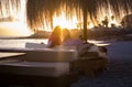 Romantic couple enjoy summer evening holiday vacation togerher sitting at the bar with beach and sunset view - concept of tourists Royalty Free Stock Photo