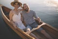 Smiling couple enjoy boating on the lake