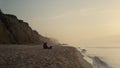 Romantic couple enjoying sunset at ocean. Loving woman and man dating on beach. Royalty Free Stock Photo