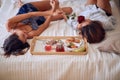 Romantic couple enjoying together at bed.Red rosses for my love girlfrend Royalty Free Stock Photo