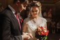 Romantic couple exchanging rings during wedding ceremony in chur Royalty Free Stock Photo