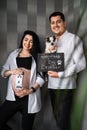 Creative couple with small dog expecting baby, Creative photoshoot for pregnancy, happy family waiting for baby boy Royalty Free Stock Photo